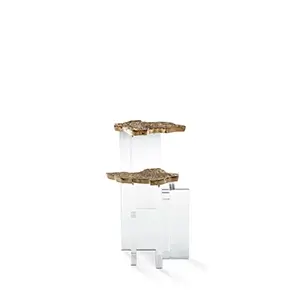 Angled view of a side table with a polished marble top and an intricate gold branch-like base.
