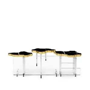 Angled view of a Nero Marquina side table with a bold black finish and sculptural gold base.
