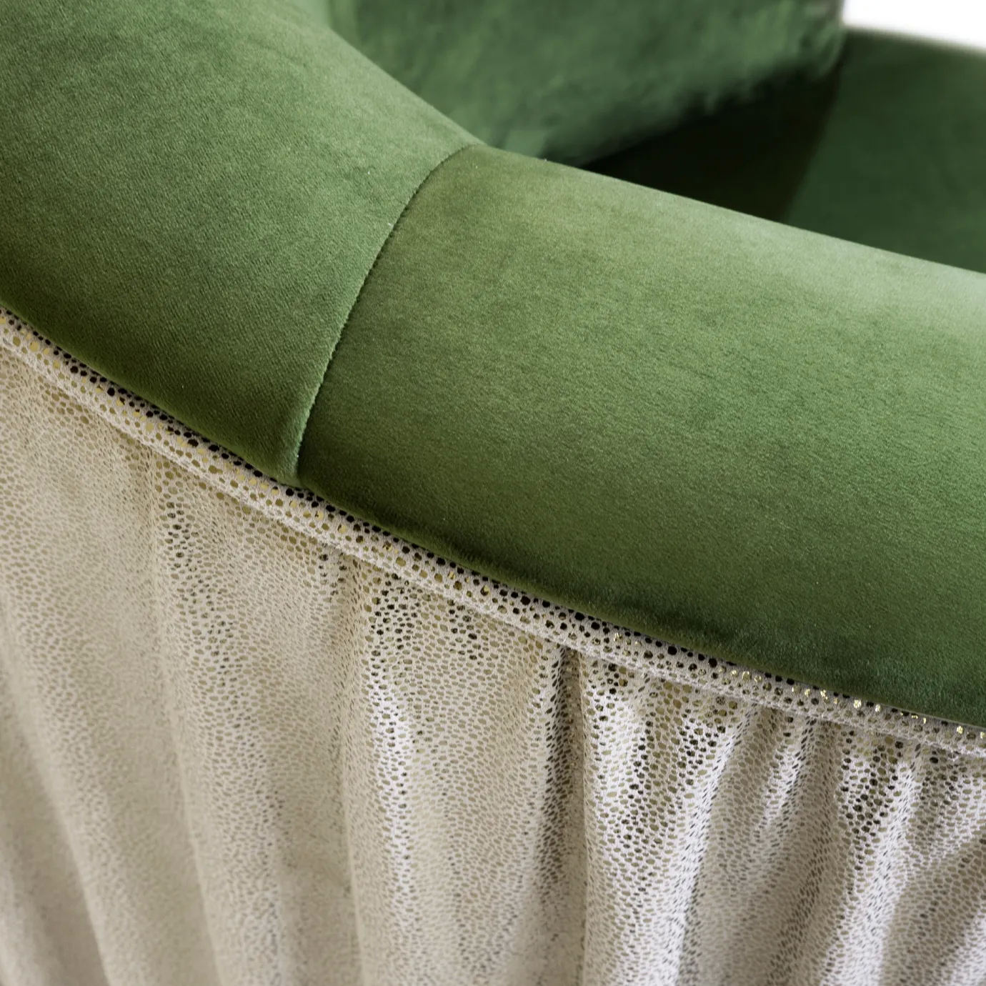 Elegant close-up of the contrast between the green velvet and the textured side detail of the Countess Chair.