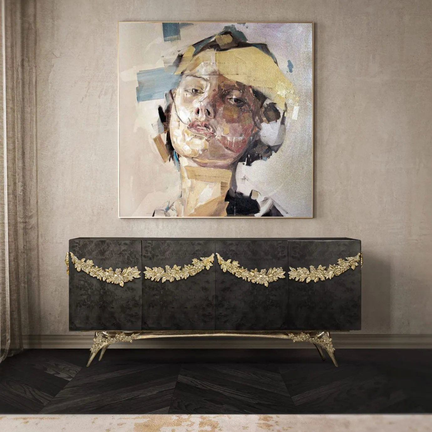 KOKET Majestic Sideboard in black poplar root veneer with ornate gold floral accents and brass legs, styled in a modern luxury interior below an abstract portrait.