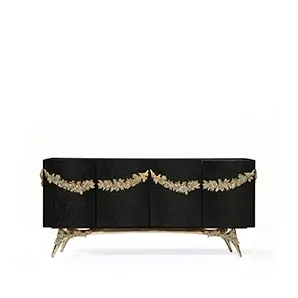 Majestic sideboard with black leather doors, gold garland accents, and a sculptural brass base.