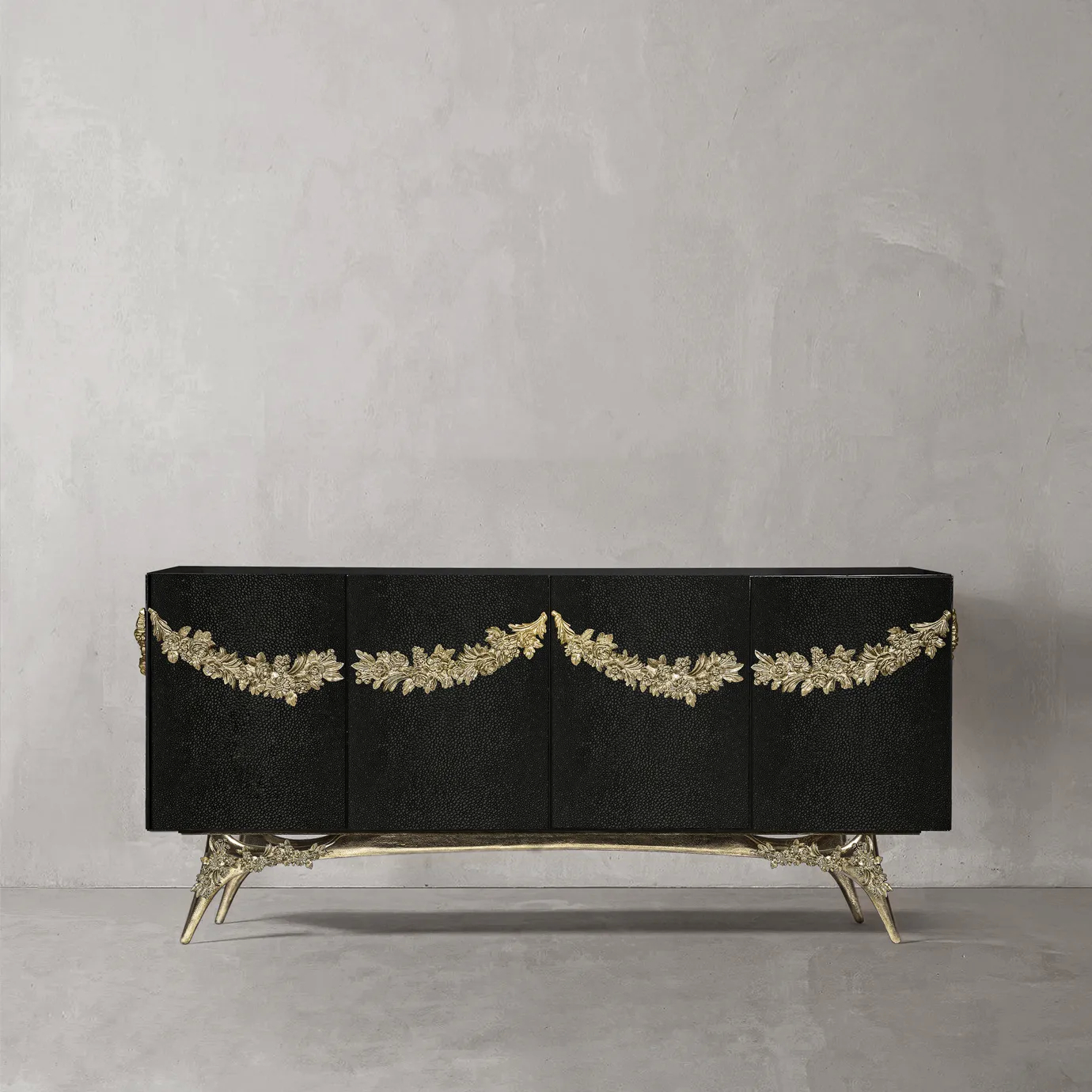 Majestic sideboard with black stingray leather doors, gold garland accents, and brass base.