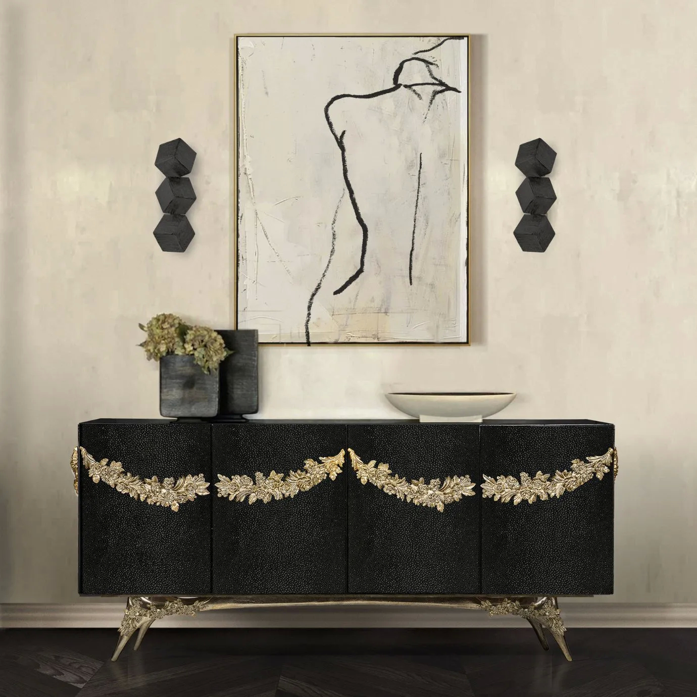 KOKET Majestic Leather Sideboard featuring black textured leather panels, ornate gold leaf detailing and sculptural brass legs, styled in a refined luxury interior.