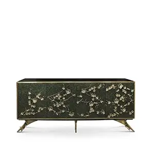 The Spellbound Peacock Feather Cabinet’s structure is adorned with greenish peacock feathers ornamented with elegant golden flower-shaped details on its four front doors.