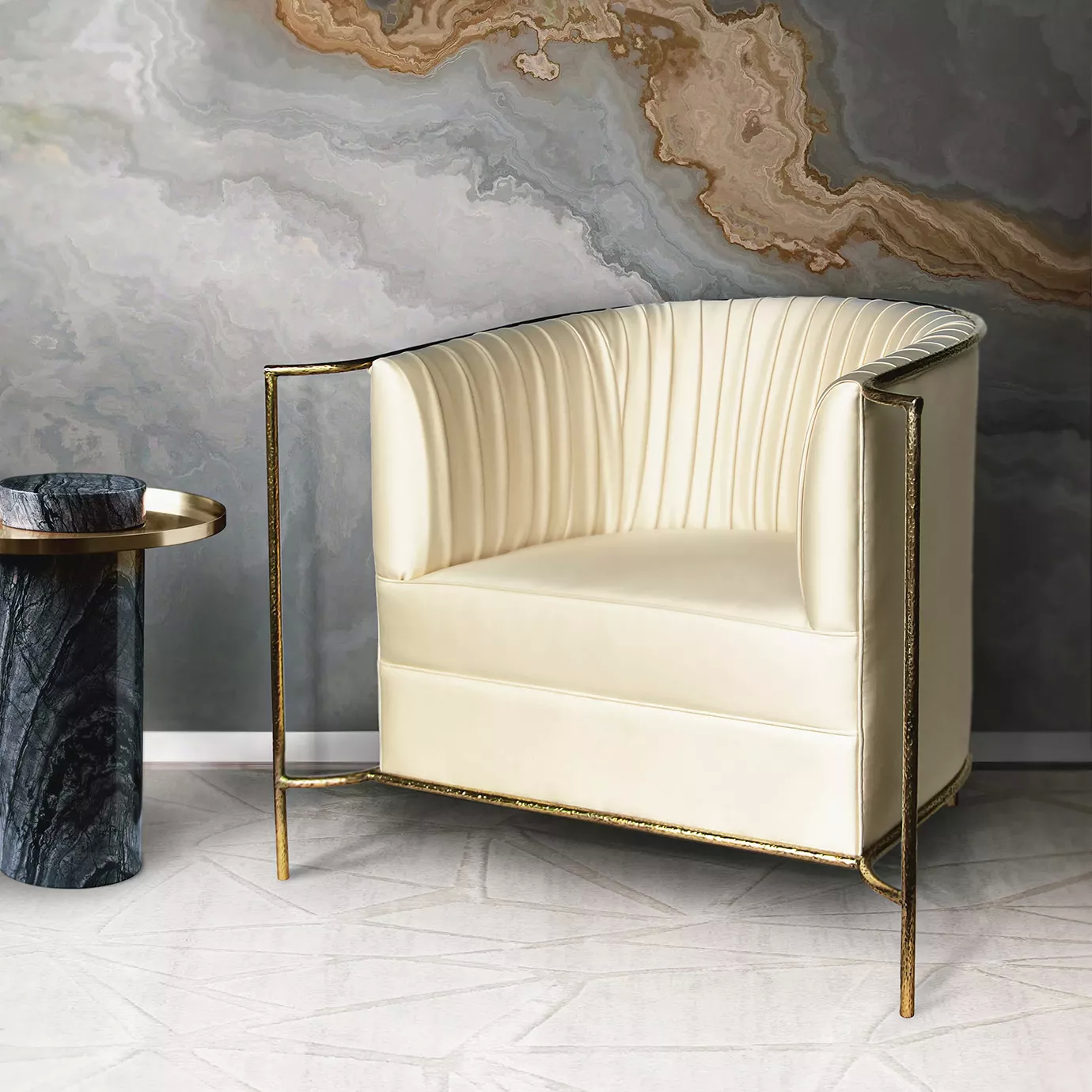 Elegant Desire Chair with golden metal frame and cream fabric upholstery with pleated details next to a Lapiaz Side Table with golden top and blue marble base.