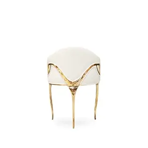 Rear view of the Chandra Dining Chair in white by KOKET, showing the open back design and sleek brass legs for a glamorous, contemporary look.