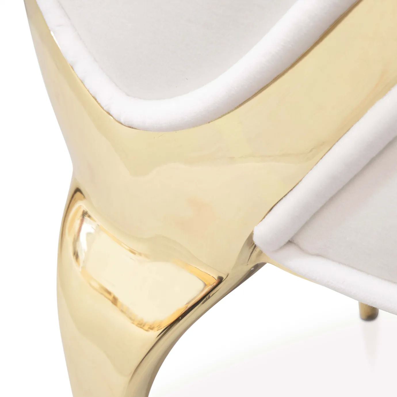Side profile of the Chandra Dining Chair in white by KOKET, showcasing the refined shape of the backrest, plush upholstery, and gold-finished brass base.
