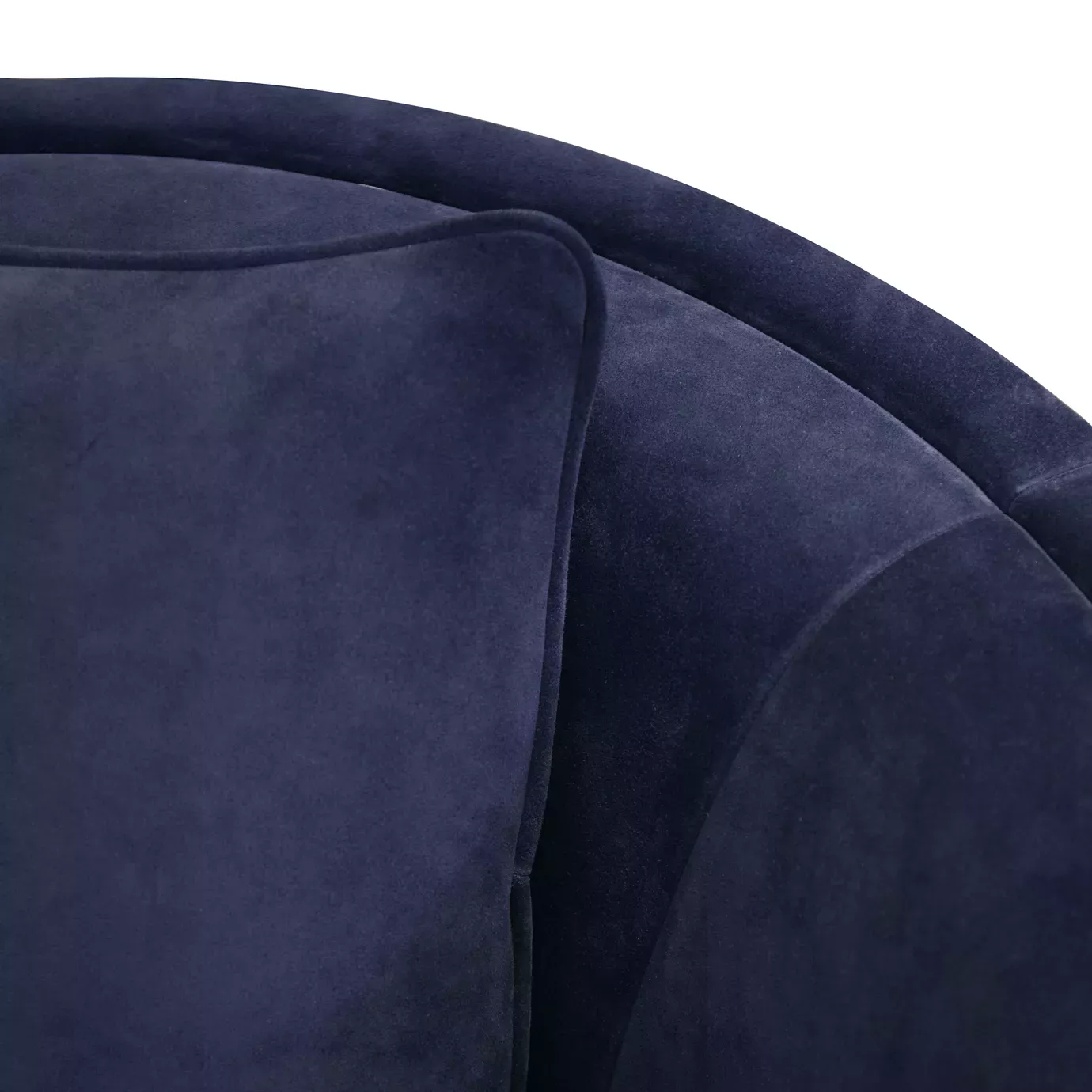 Elegant close-up of the deep blue velvet upholstery and cushion of the Mandy Armchair.