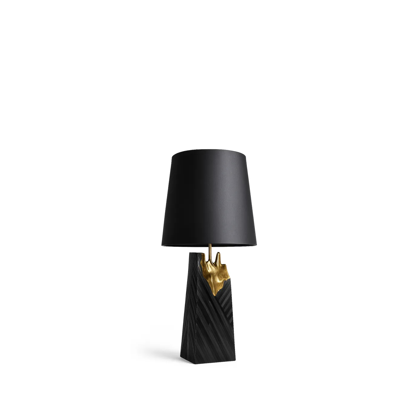 A luxurious Gild Table Lamp featuring a black conical shade, a golden organic-shaped stem, and a textured black trapezoidal base, on white.