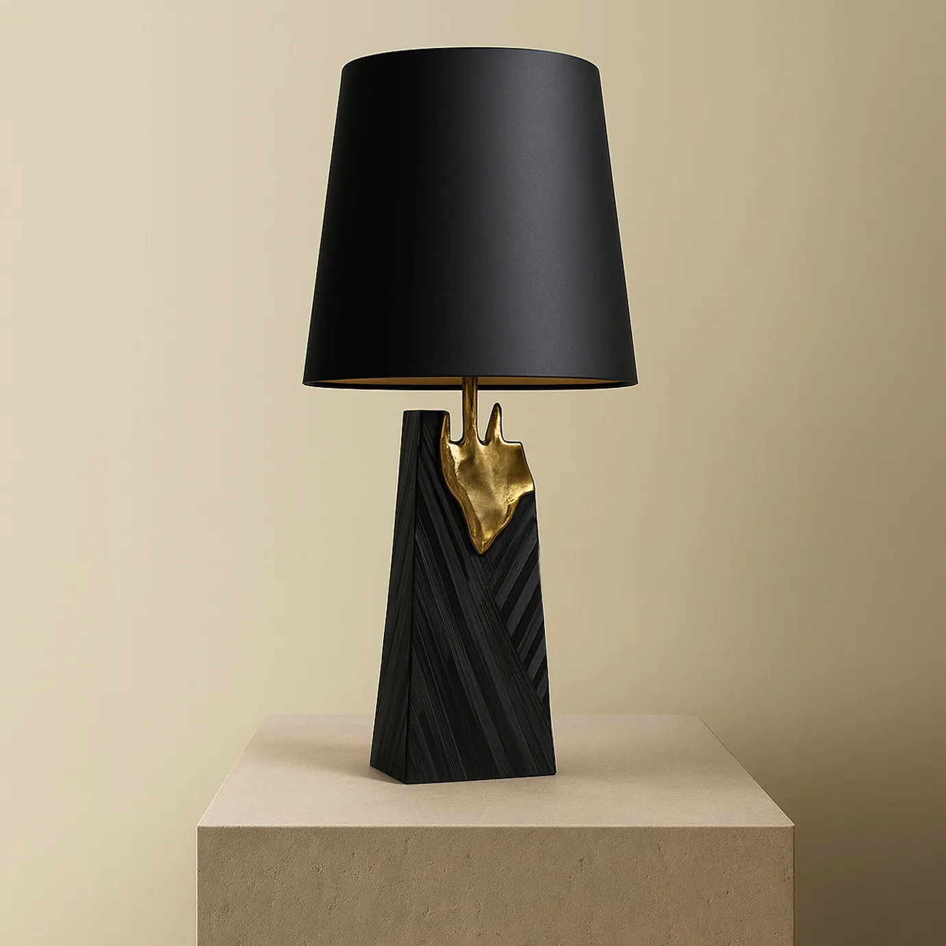 A luxurious Gild Table Lamp with a black shade, a black textured base, and a prominent gold metallic detail, on a pedestal.