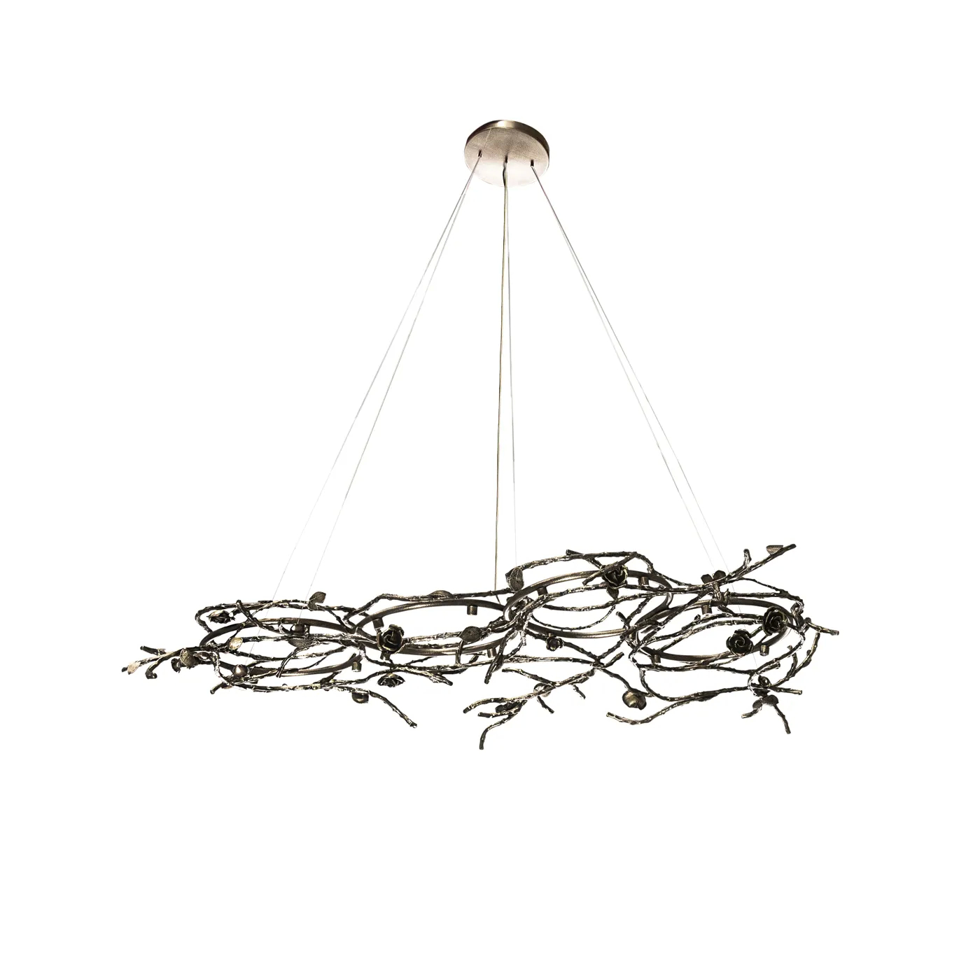 Rose Chandelier in aged brass with sculptural vine-like branches and delicate bud details, suspended by thin cables in a modern interior setting.