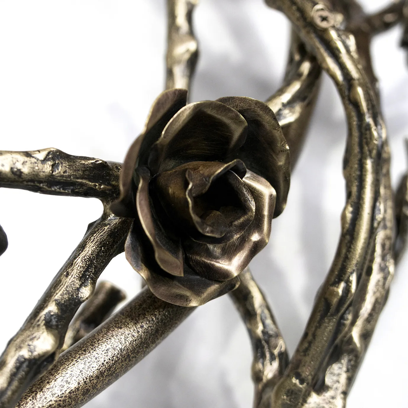 Close-up of the Rose Round Chandelier in aged brass, featuring sculpted rose and branch elements with antique finish and intricate metalwork craftsmanship.