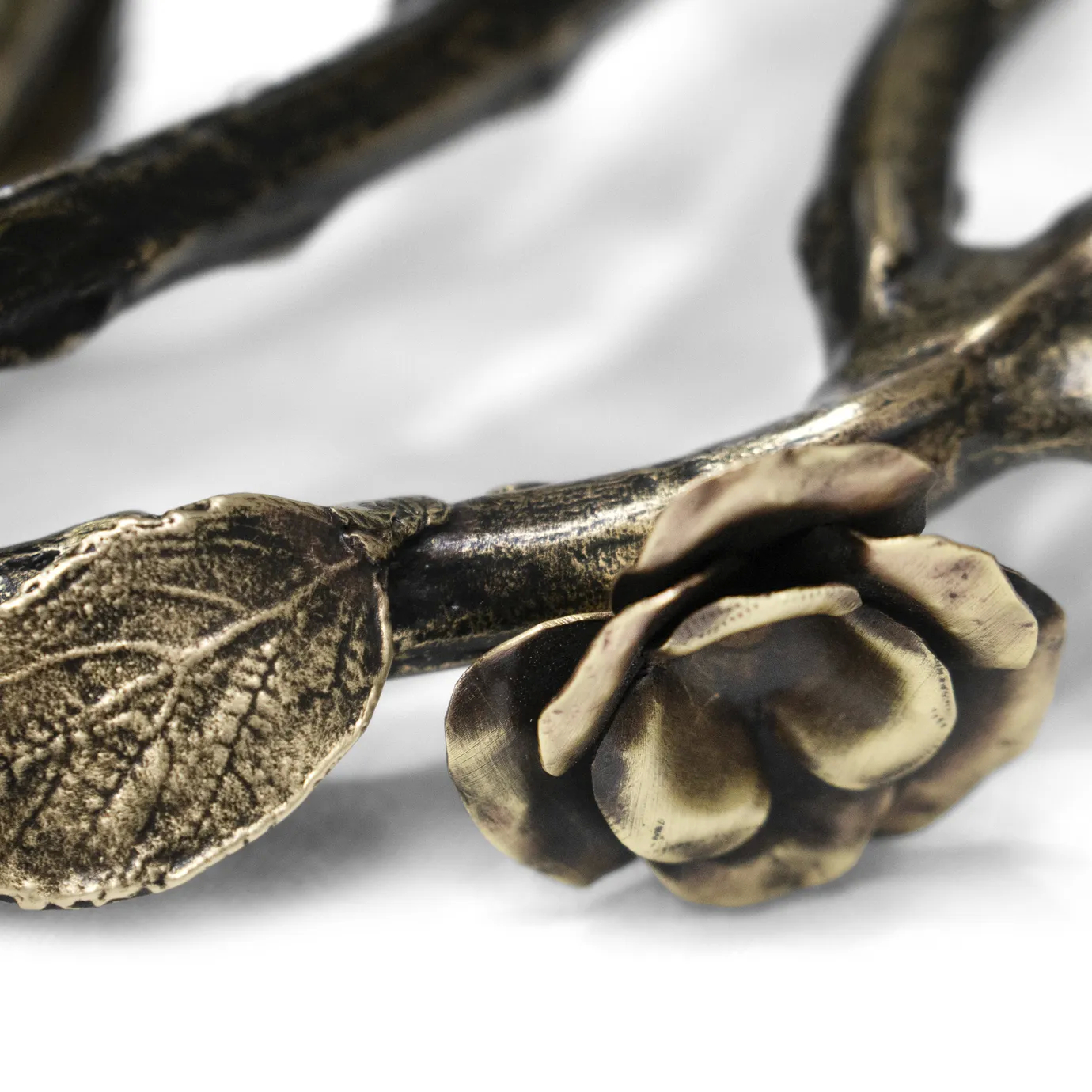 Close-up of the Rose Round Chandelier in aged brass, featuring sculpted rose and branch elements with antique finish and intricate metalwork craftsmanship.