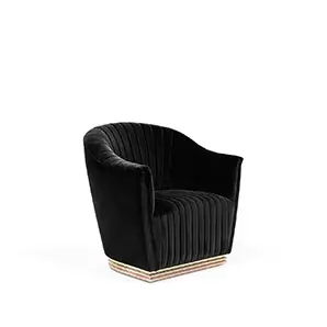 Elegant Mia Armchair upholstered in black velvet with pleated details and a base with brass.
