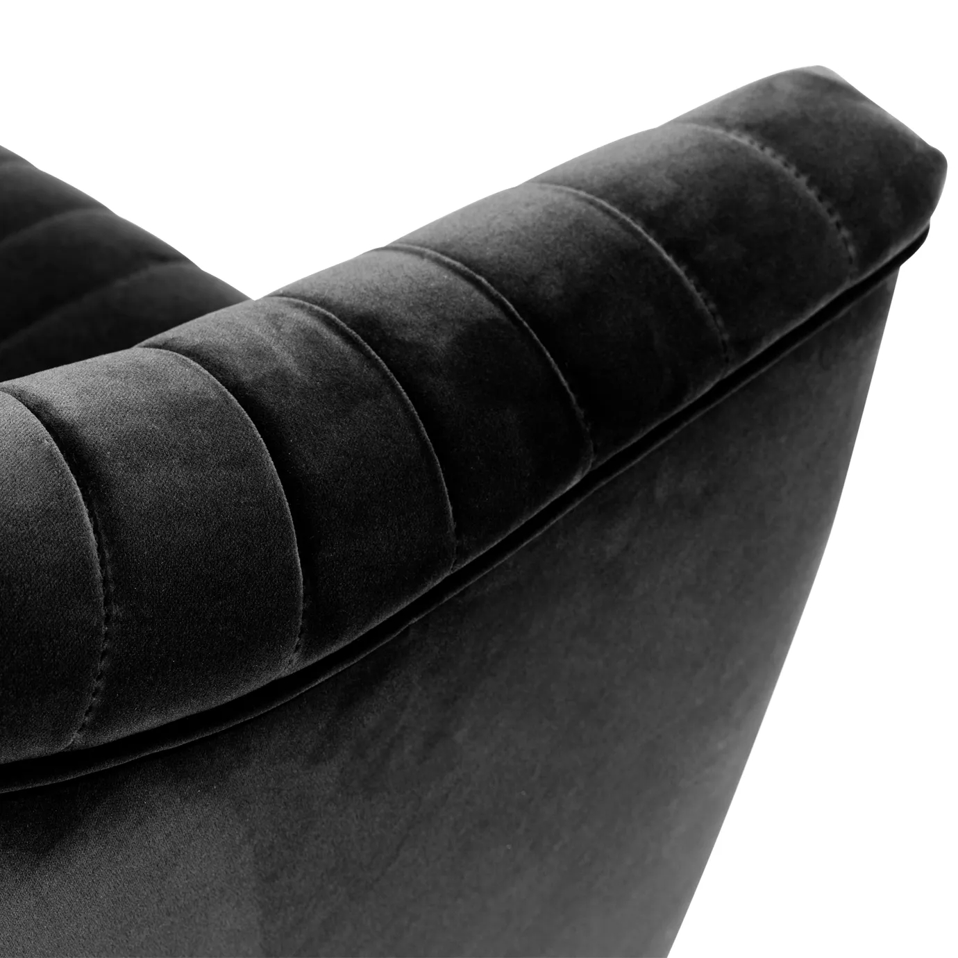 Elegant close-up of the pleated detail of the black velvet of the Mia Armchair.