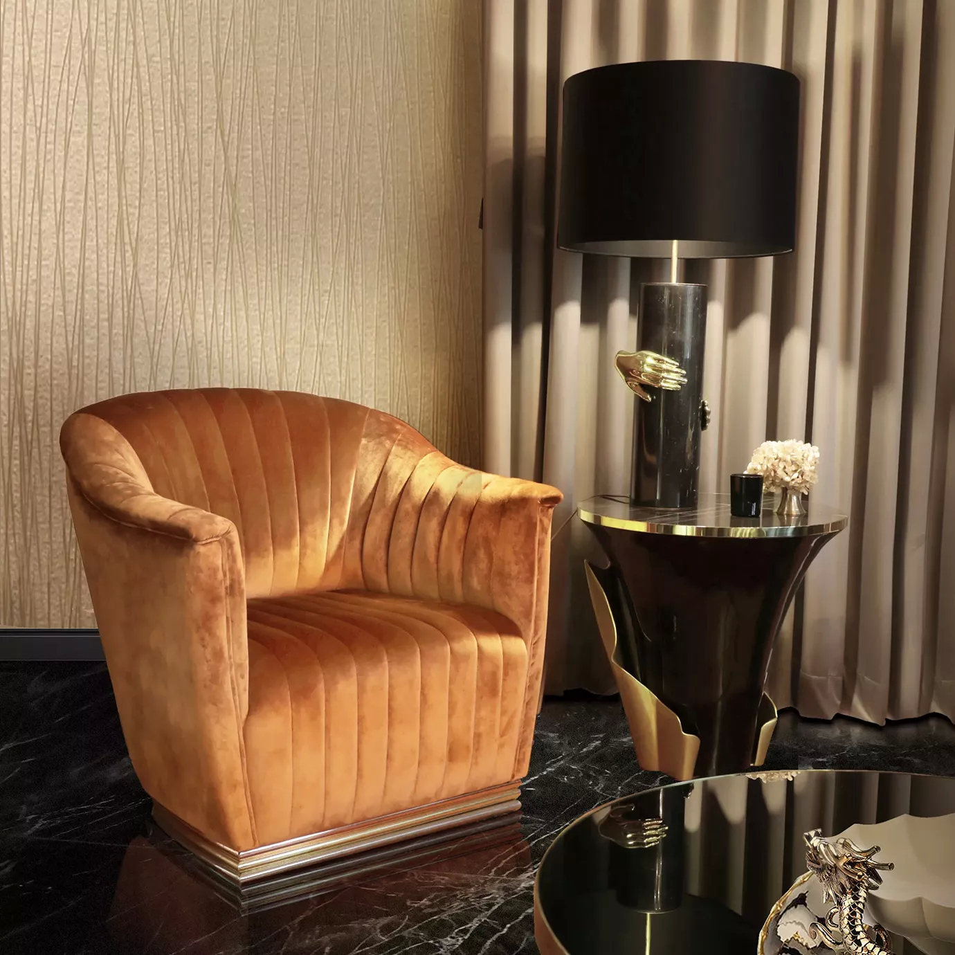 Elegant Mia Armchair upholstered in orange velvet with pleated details in a sophisticated living room with a Yasmine side table.
