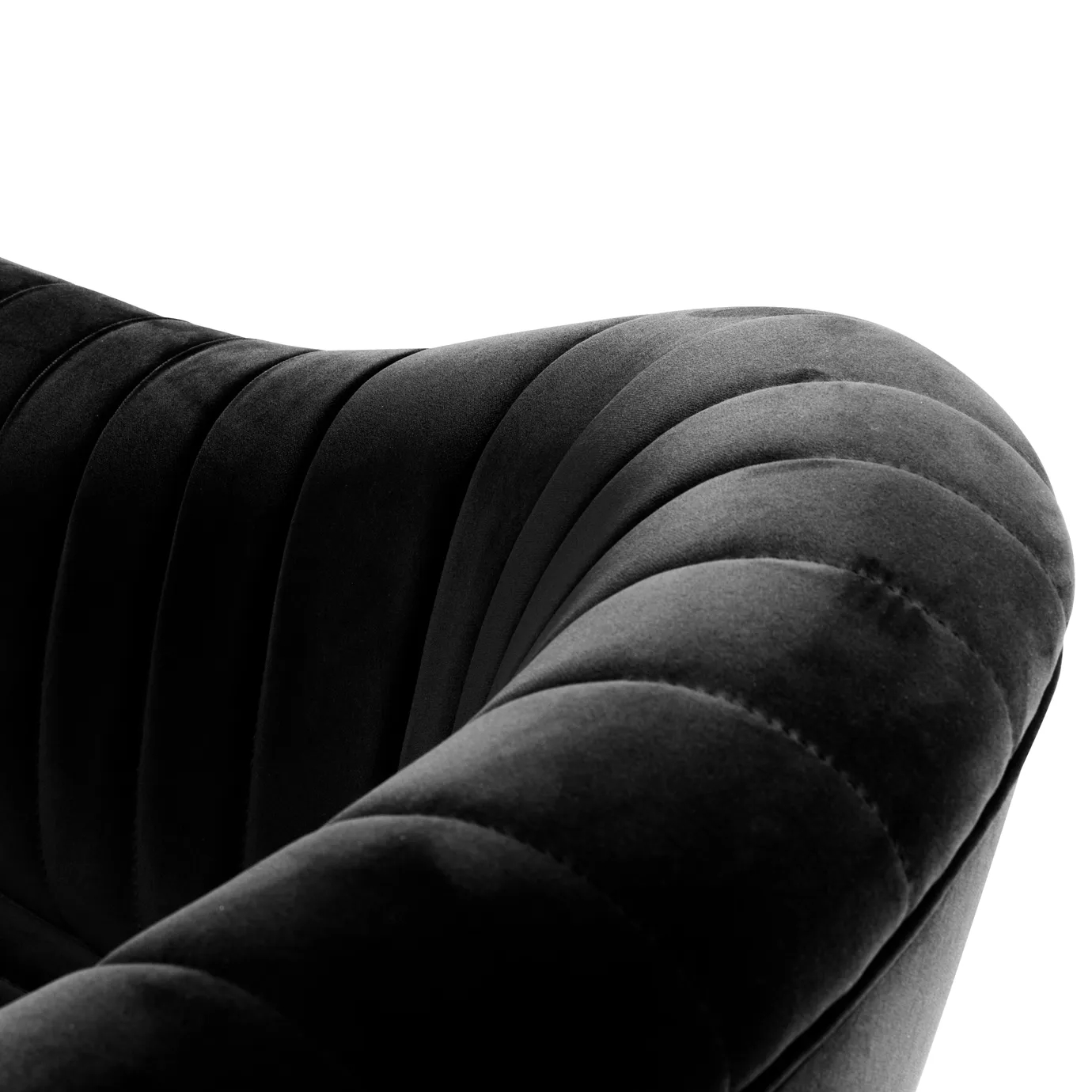 Elegant close-up of the pleated detail of the black velvet of the Mia Armchair.