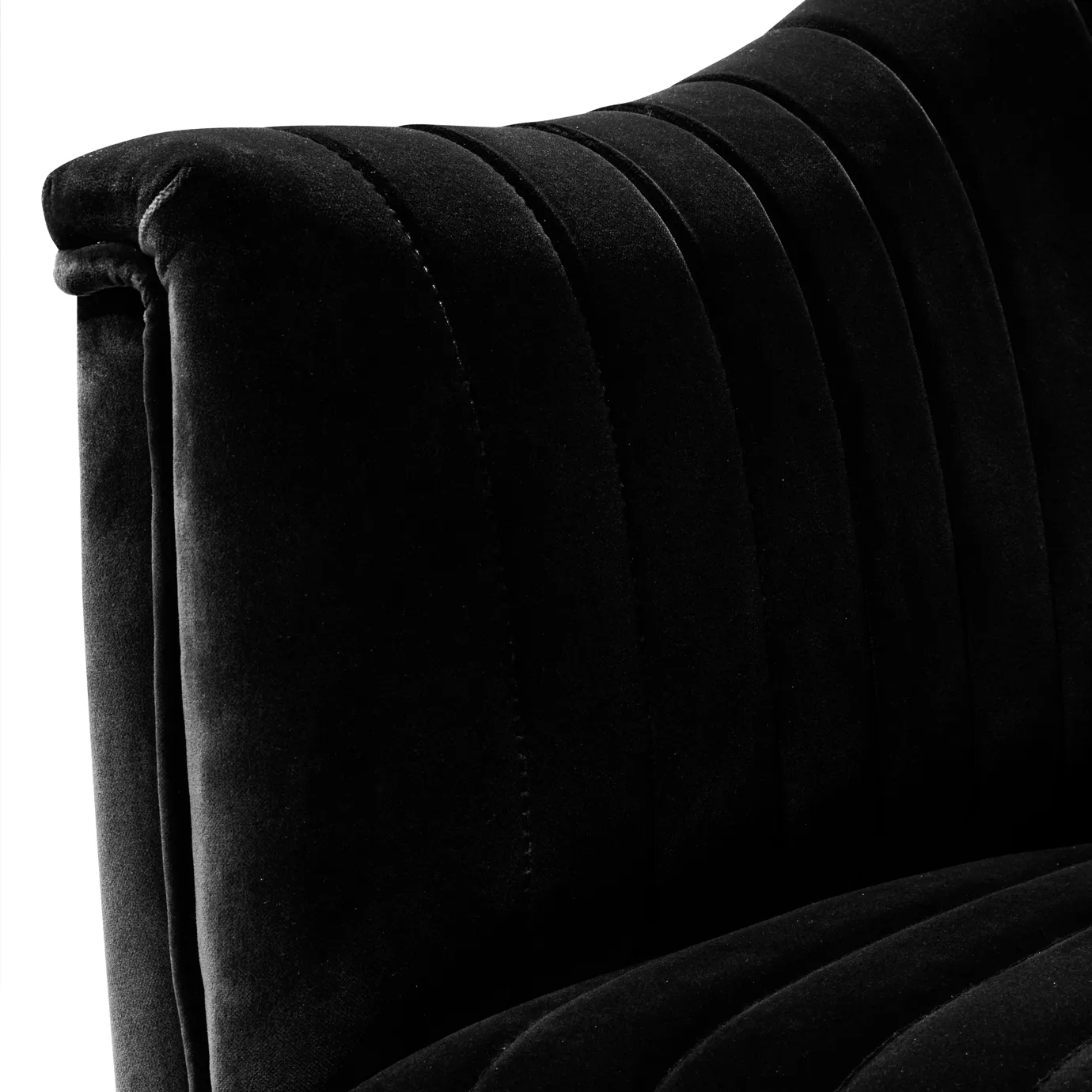 Elegant close-up of the pleated detail of the black velvet of the Mia Armchair.