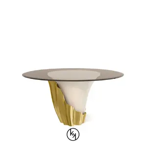 Featuring a sultry silhouette, Yasmine Side Table has a glass tabletop, set on a solid wooden cream base, adorned with a golden structure that arches back and forth.