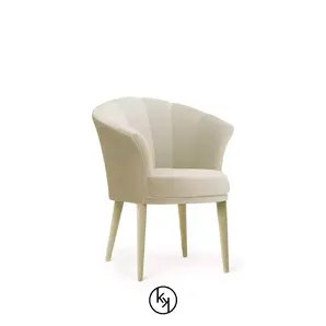Besame Dining Chair with a cream-colored, fan-pleated back, a cushioned seat, and light-colored wooden legs.
