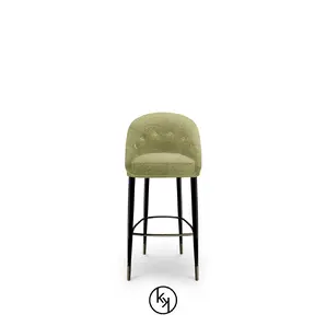 Aberdeen Counter Stool by KOKET pairs a sculptural base with plush upholstery