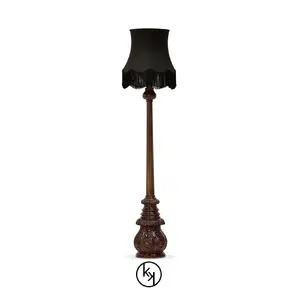 Elegant Lotus Floor Lamp with an ornate sculpted base in brown tones, a decorative vertical stem, and a black lampshade with fringe details.