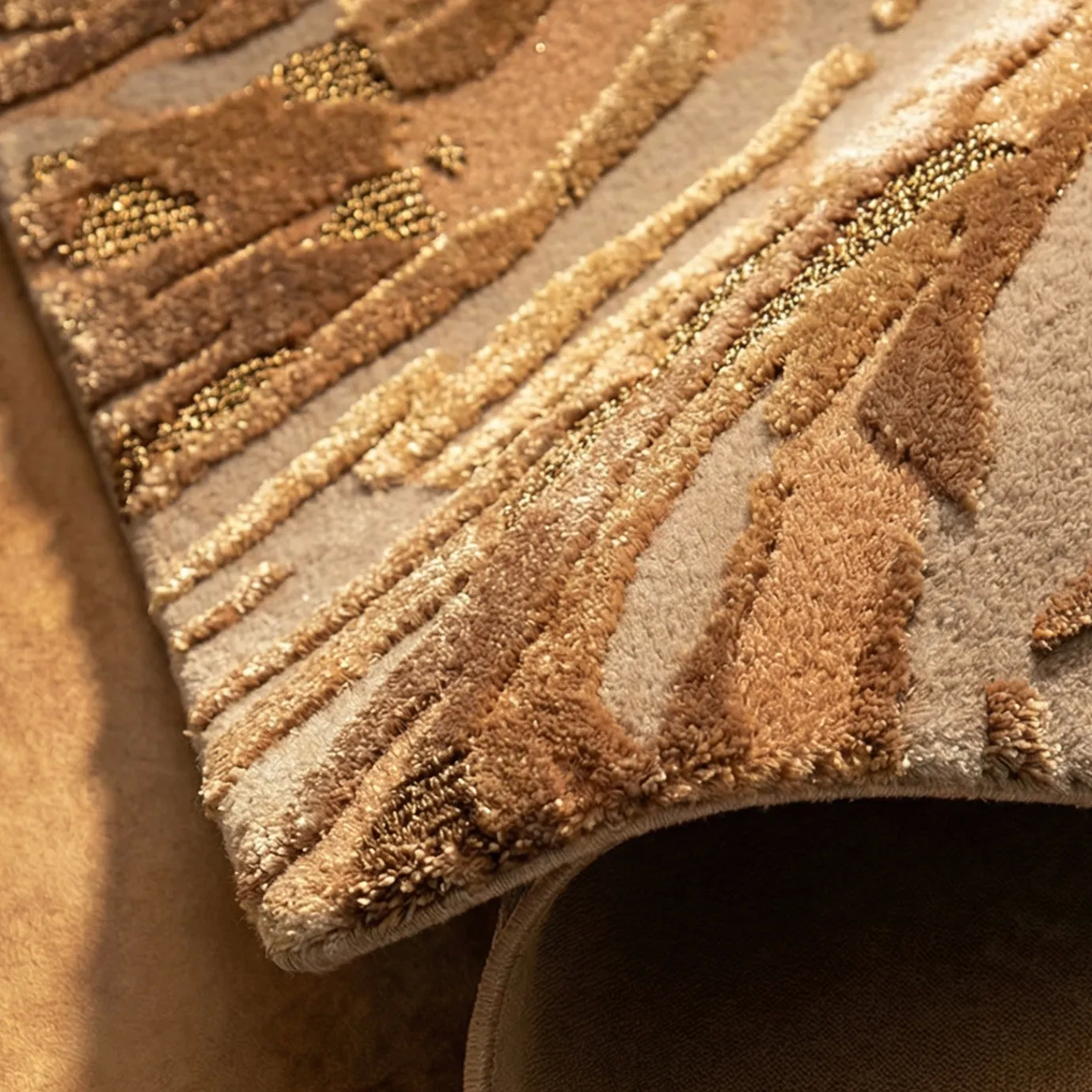 Macro view of the KOKET Poppy Bronze luxury rug, showing the high-end hand-tufted textures, shimmering metallic threads, and detailed botanical relief.