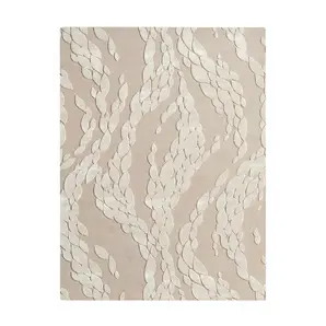 Full view of a neutral KOKET luxury rug featuring a contemporary leaf motif with hand-tufted relief textures in a tonal cream palette.