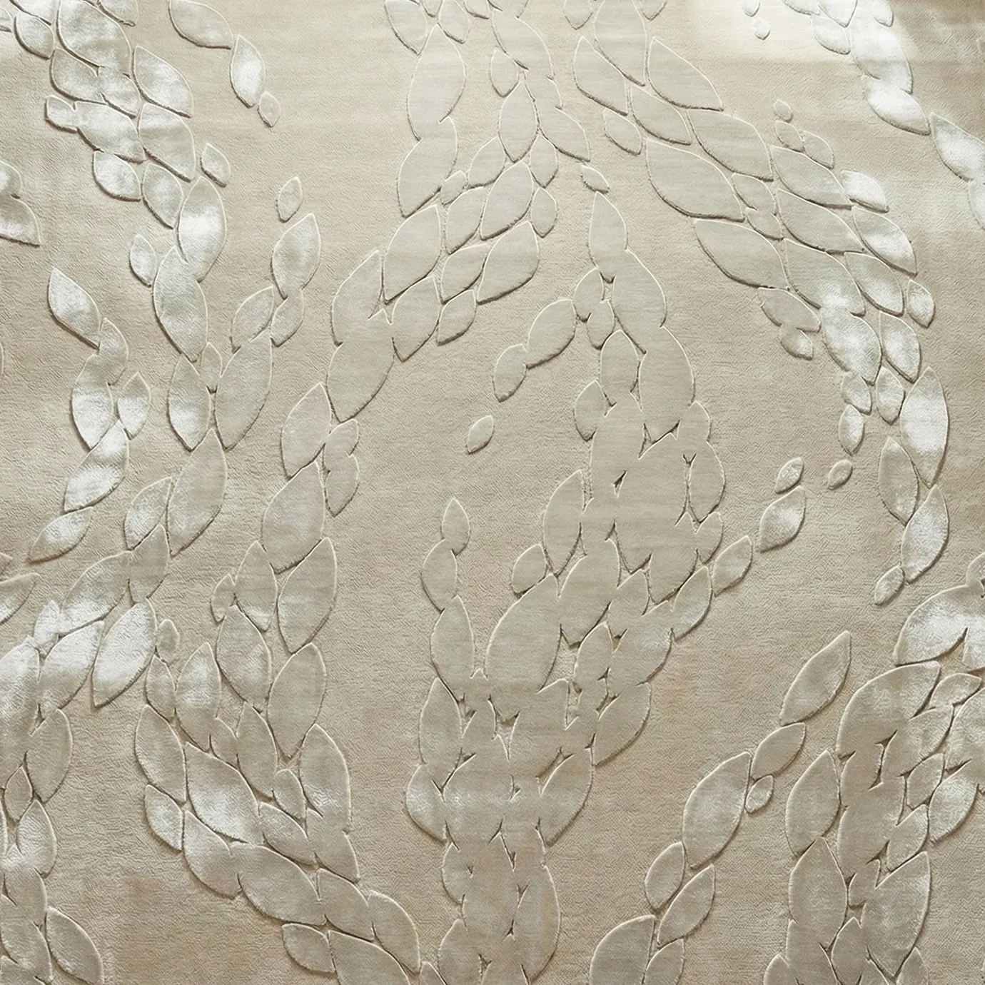 KOKET Ophidia Beige Rug, close-up of beige wool base with raised leaf-like pattern in bamboo silk relief