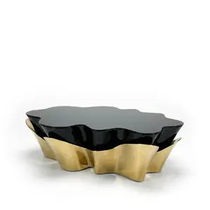 Yasmine Coffee Table by KOKET with sculptural polished brass base and glossy black lacquer top, luxury contemporary coffee table design.