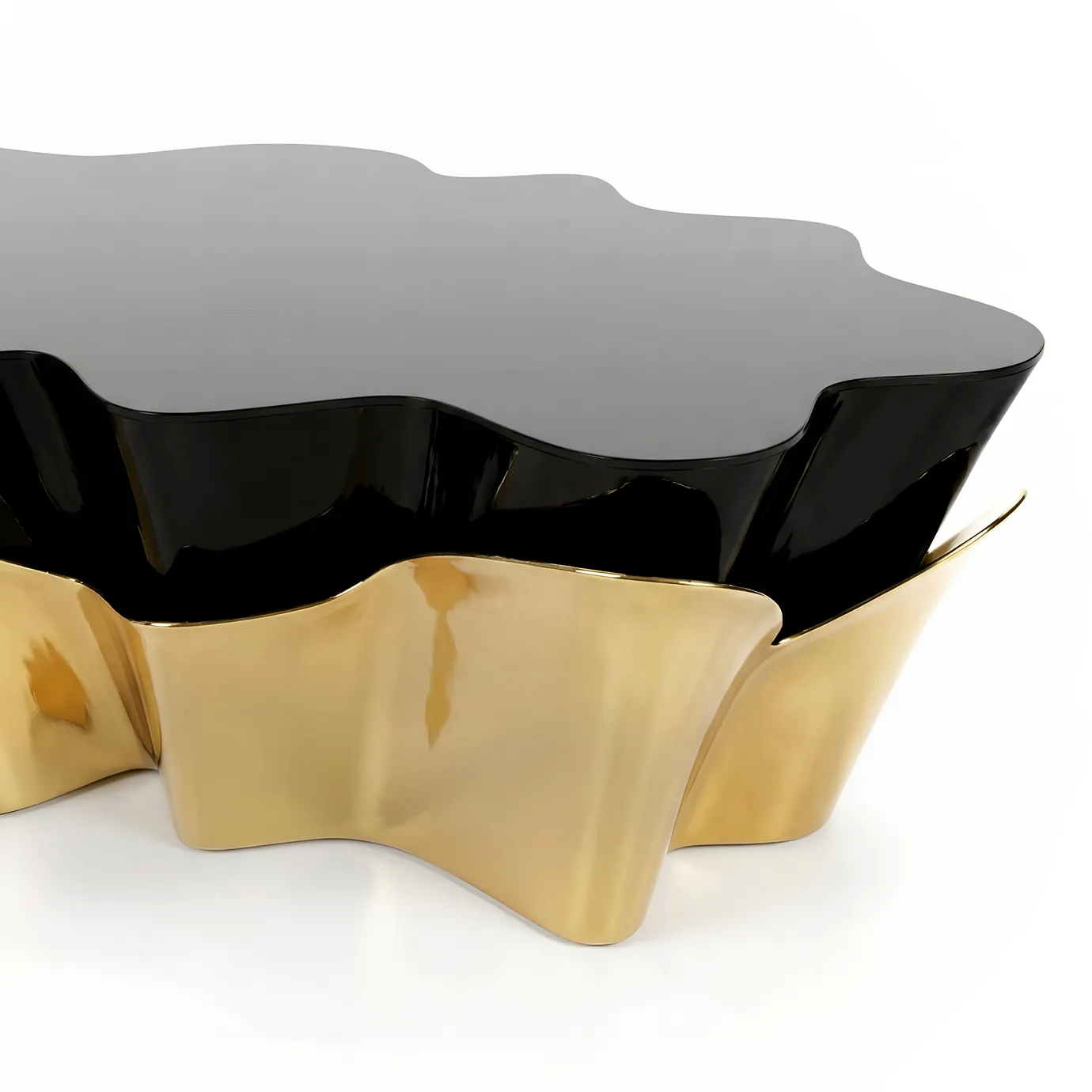 Detail of the Yasmine Coffee Table by KOKET showcasing the sculptural polished brass base with fluid curves and glossy black lacquer top, luxury contemporary coffee table design.