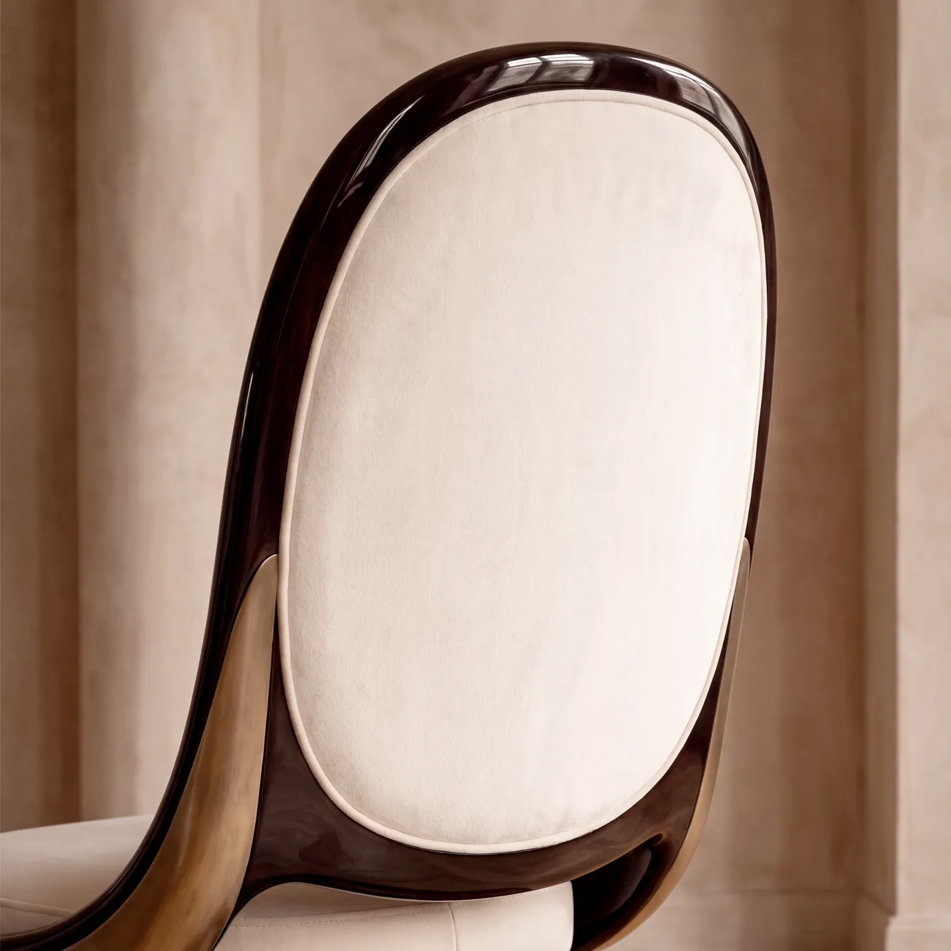 Detail of Gabrielle dining chair by KOKET, cream velvet oval back in a black lacquer shell, brushed brass and walnut burl.