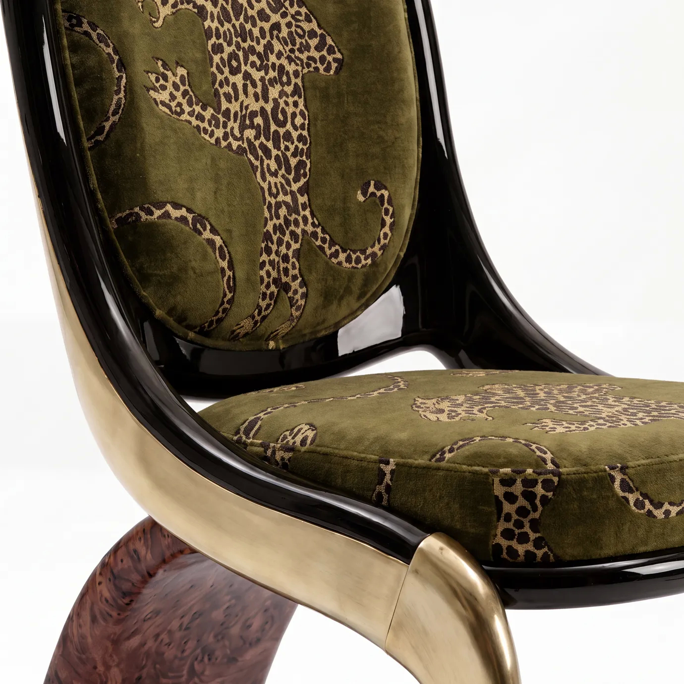 Detail of Gabrielle dining chair by KOKET, gold leopards on olive velvet framed in black lacquer over brass and walnut burl.