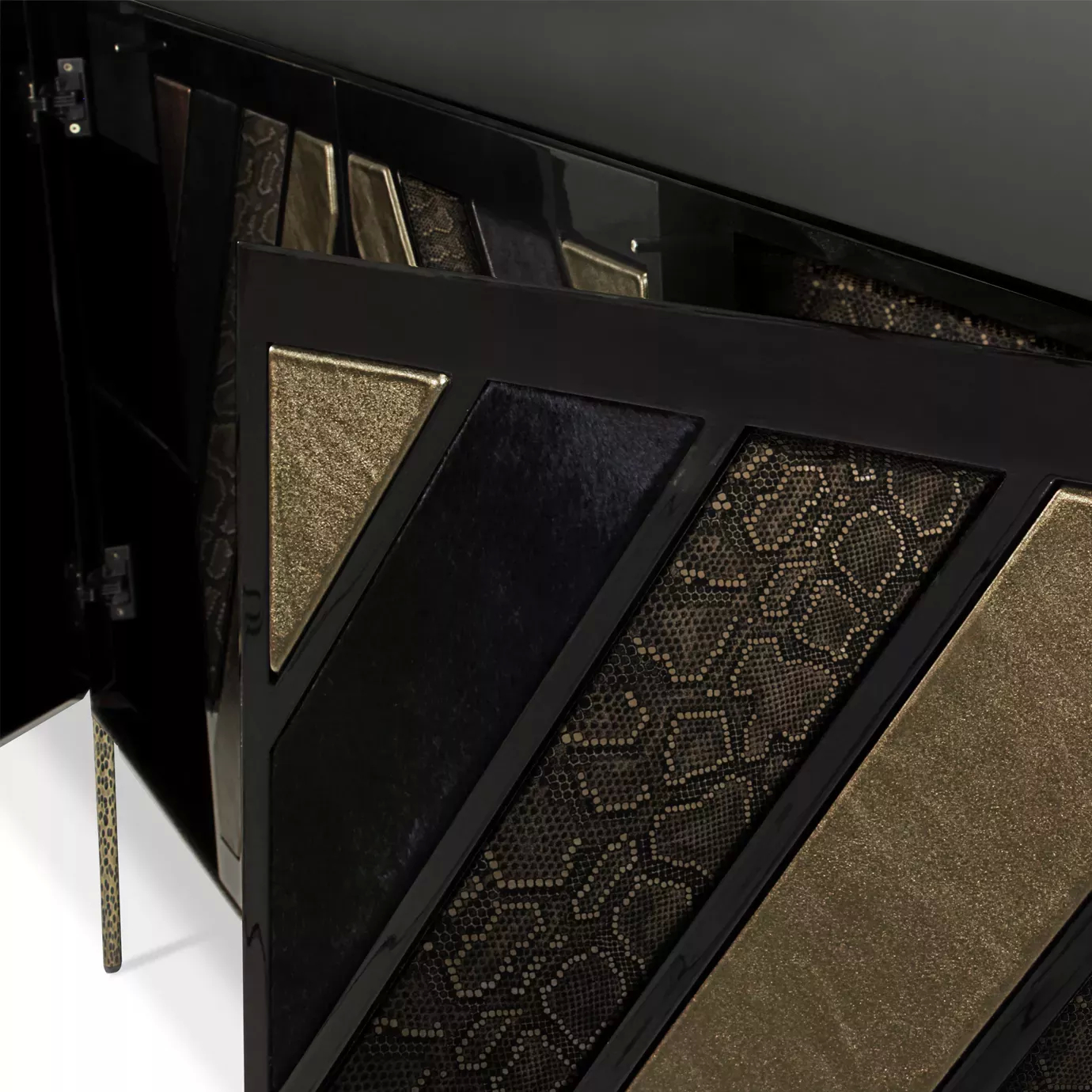 Detail of the Opium Cabinet doors with geometric textures in black and gold.