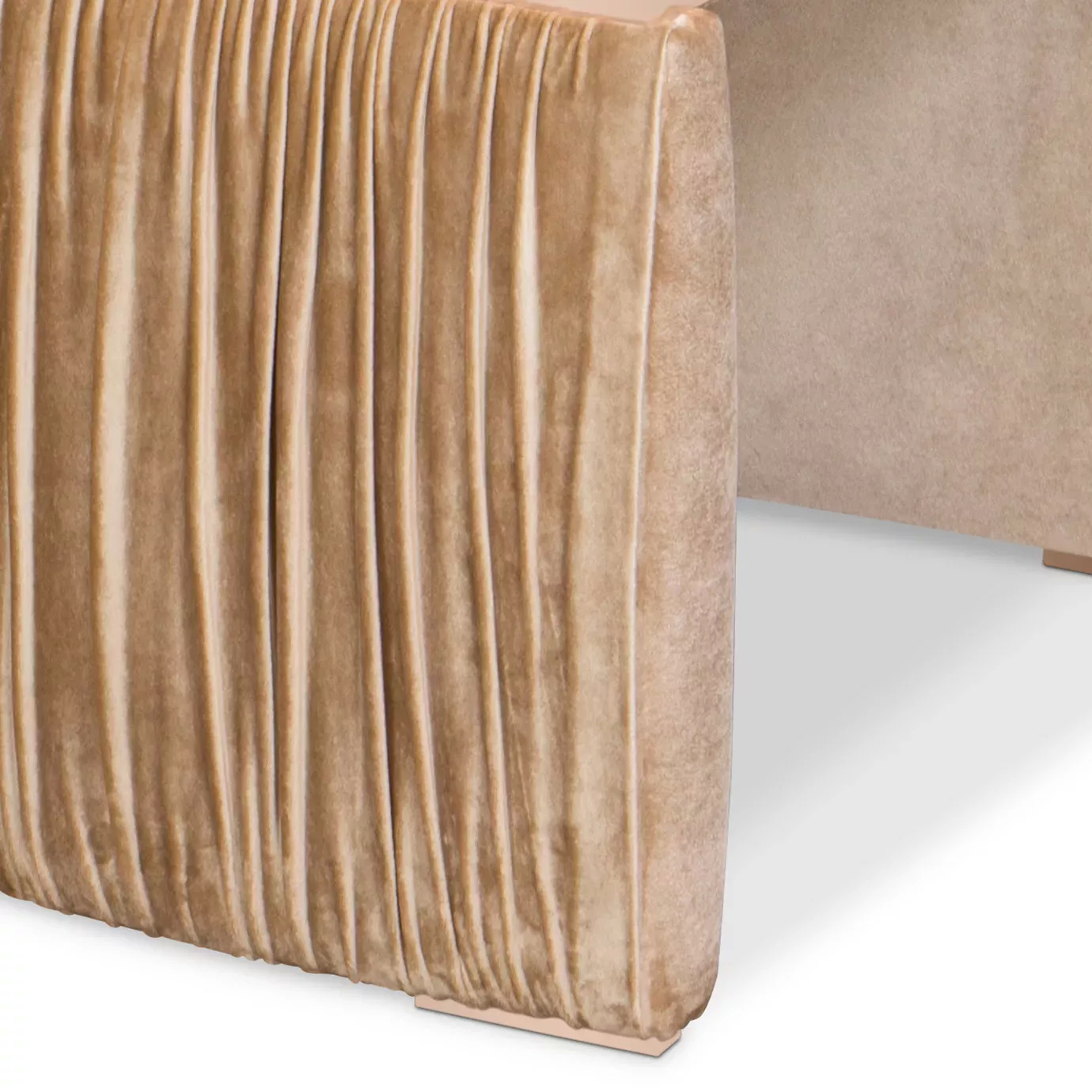 Elegant close-up of the peach-toned velvet texture with pleated detail of the Cuff Chair.