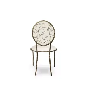 Enchanted Dining Chair: with an elegant backrest resembling branches, this chair has a luxurious white upholstery.