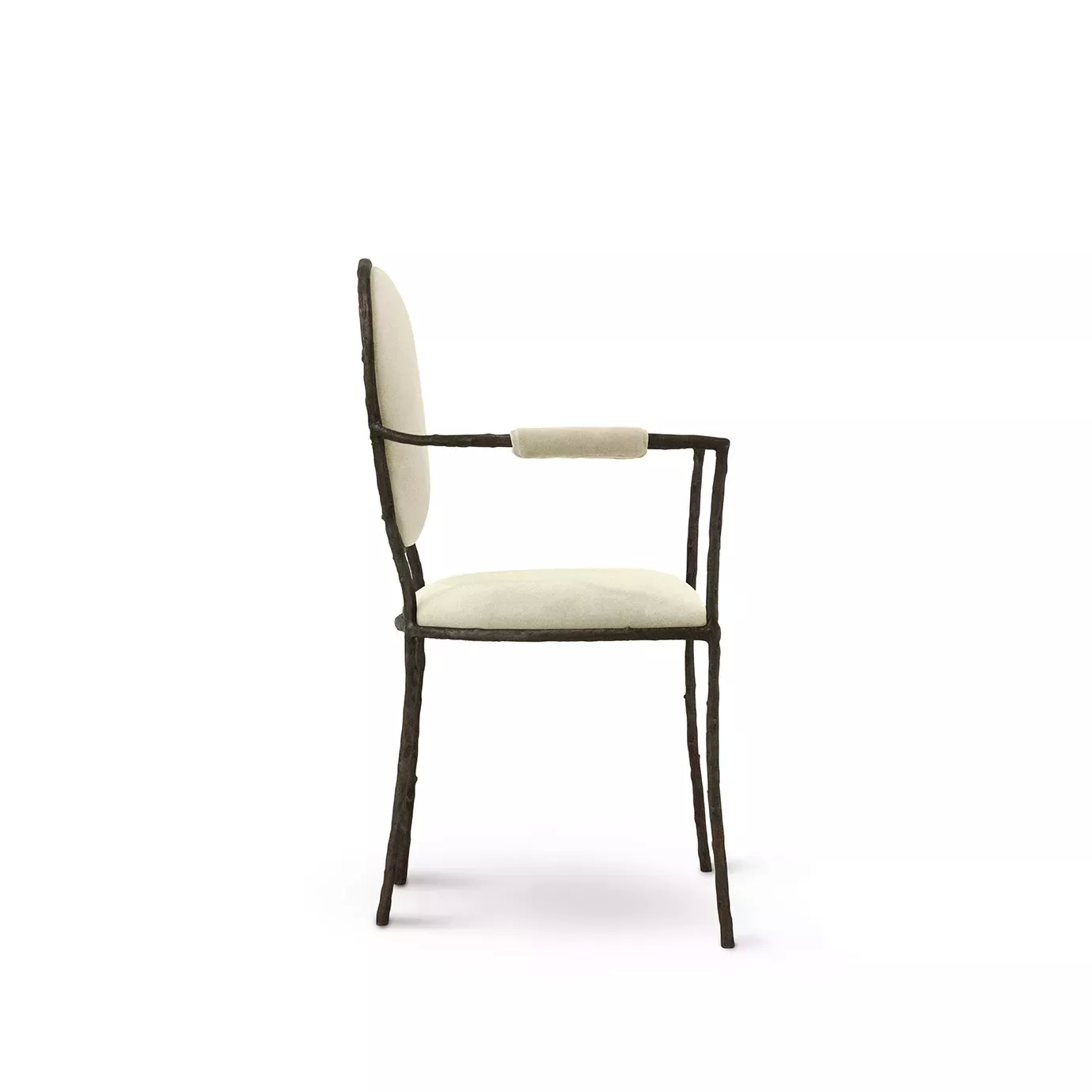 Side view of the Enchanted Arm Dining Chair, showcasing its aged brass frame resembling branches, combining with the cream upholstery.