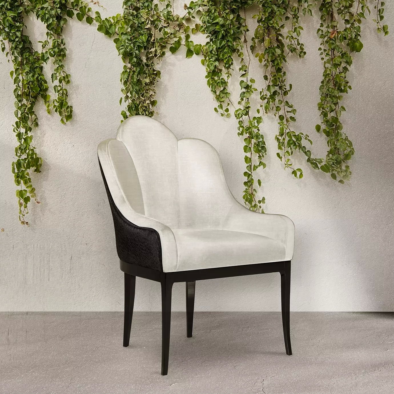 Elegant Anastasia Dining Chair upholstered in white velvet with a dark textured side detail and dark legs against a wall with climbing plants.