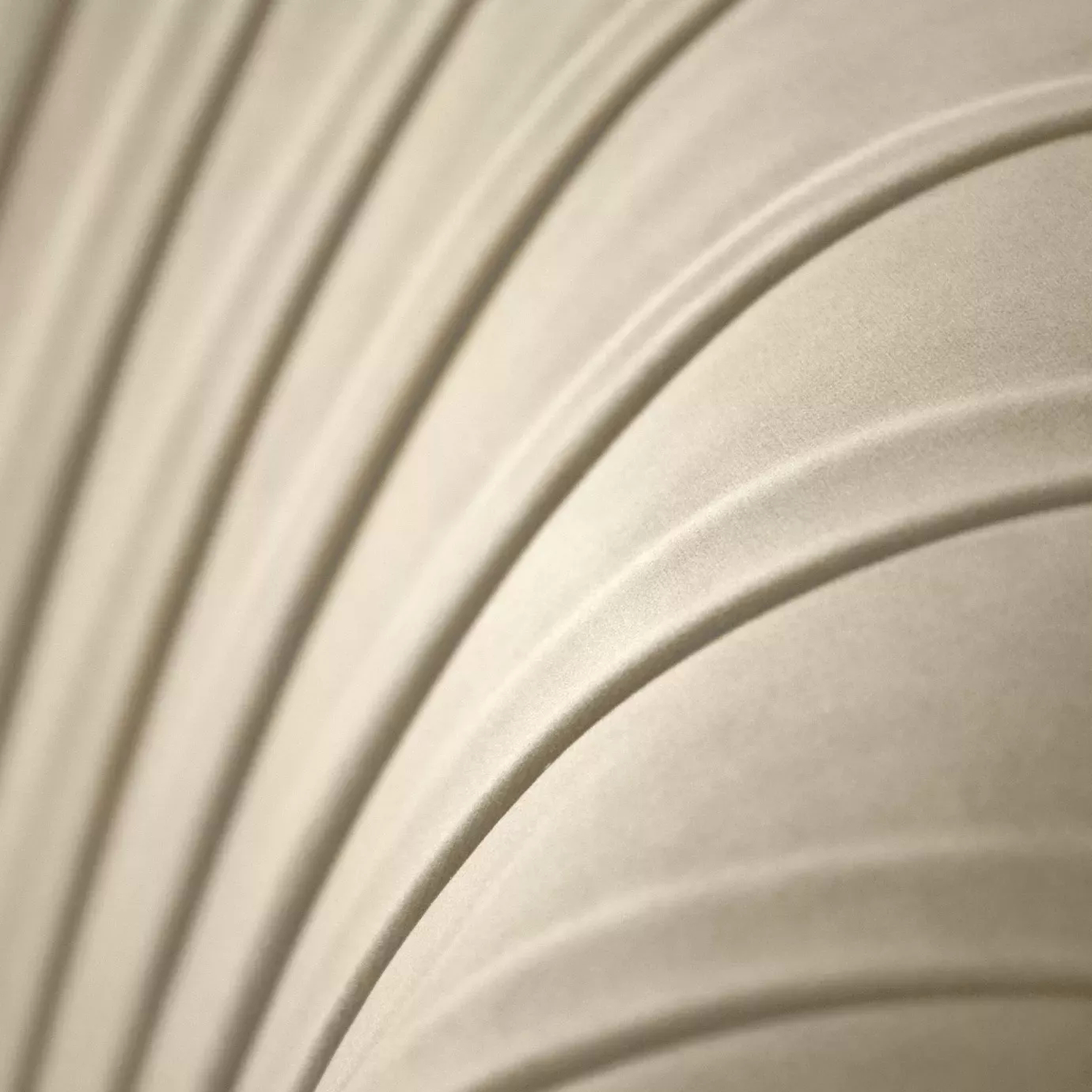 Elegant close-up of the pleated detail of the cream fabric of the Kelly Sofa.