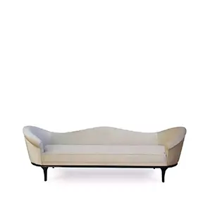 The Colette Sofa by Koket features a gently curved silhouette, upholstered in a soft, light-colored fabric, and supported by sleek, dark legs.