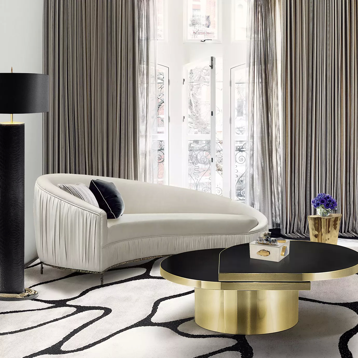 Elegant living room with a Vamp Sofa in cream fabric with a pleated detail and golden metal base, decorative cushions, a Tears Coffee Table, and an Reptilian Floor Lamp.