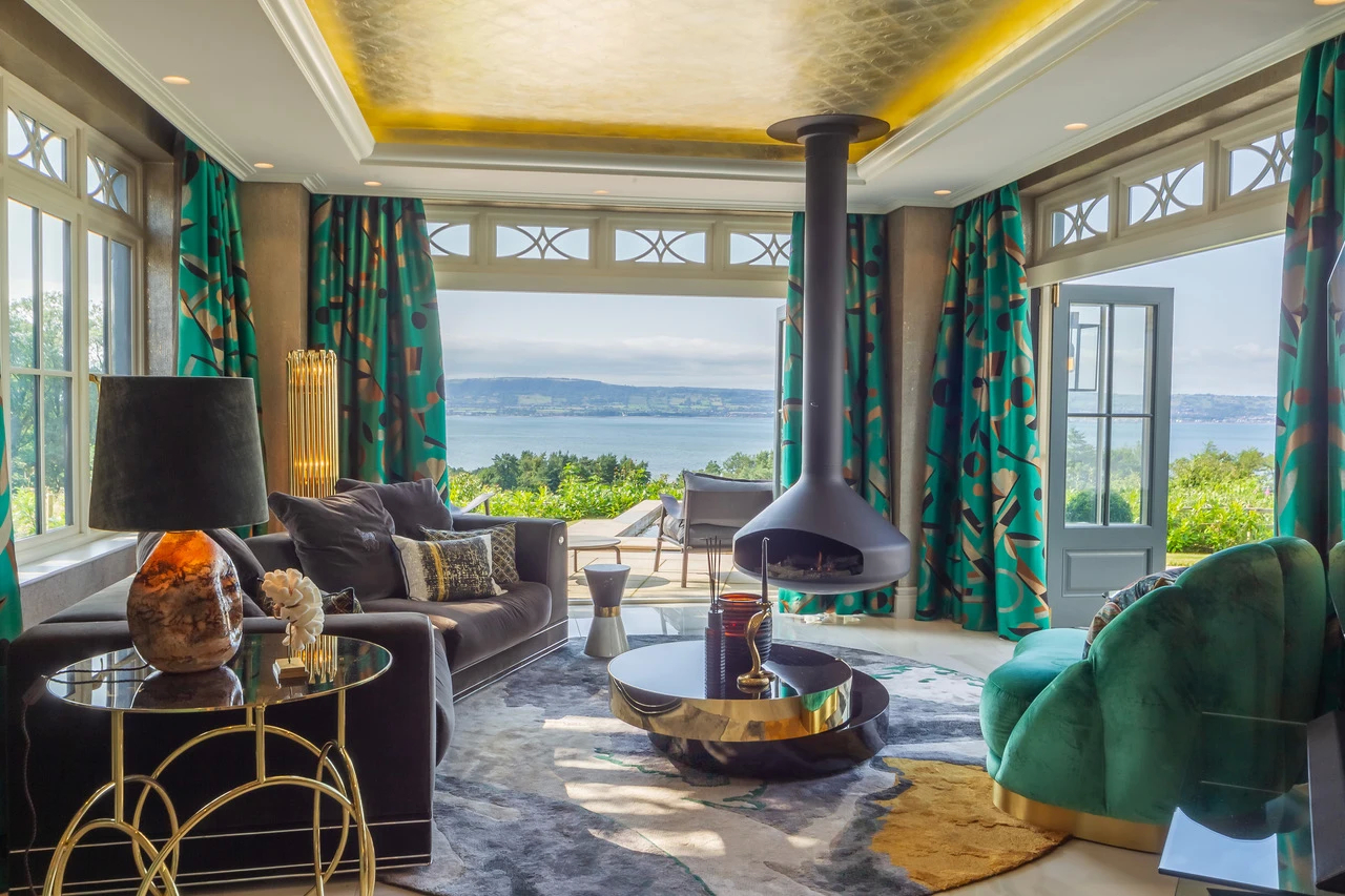 Overlooking Belfast Lough: Living room with a view, featuring a black hanging fireplace and a Kiki Side Table.