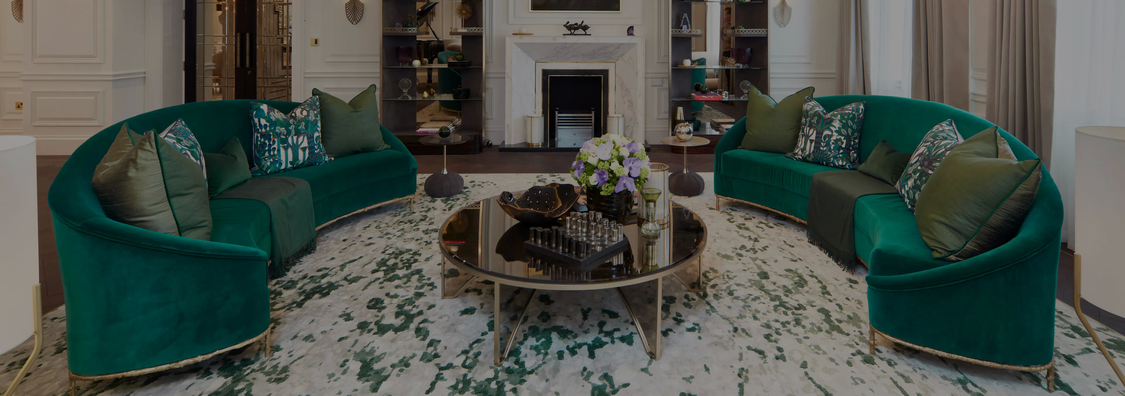 Labor of Love: Two Naomi chairs with golden velvet upholstery and black legs, with a decorative glass vase.