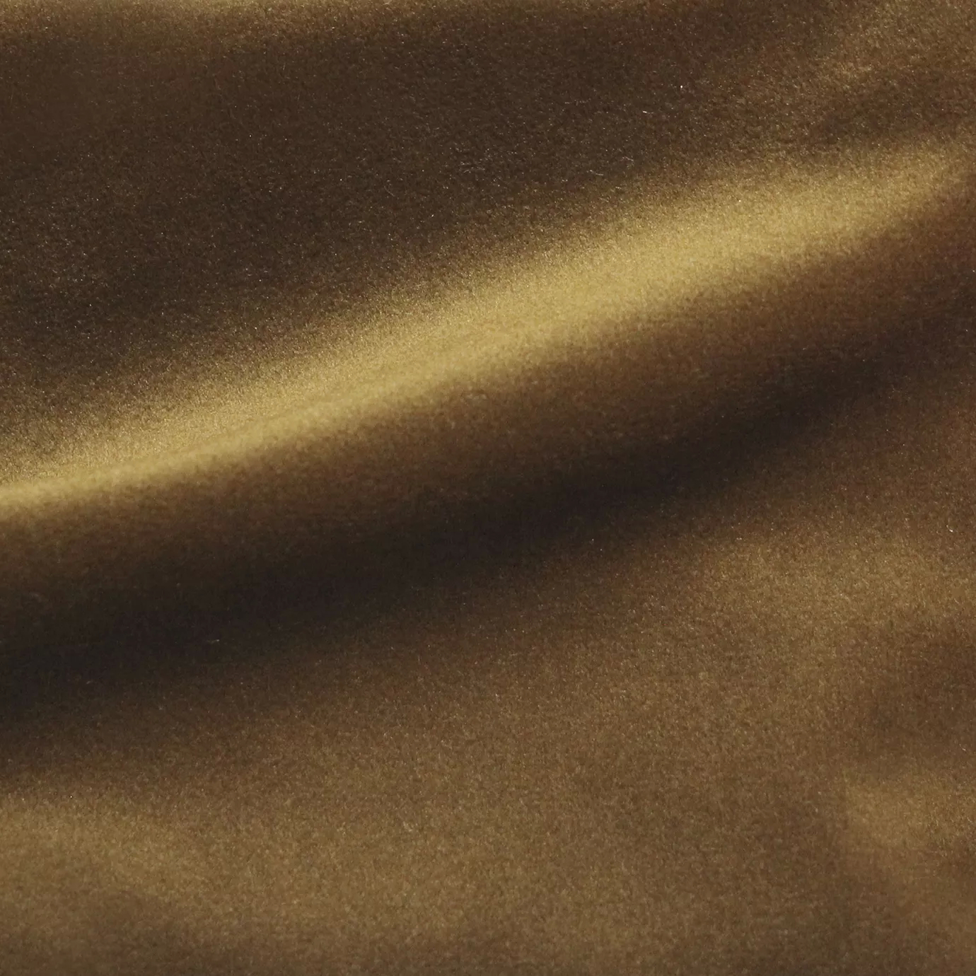 Elegant close-up of a Cozy Velvet Amber fabric swatch in a rich and warm amber tone, showcasing its velvety texture and the gentle folds that capture light with a deep sheen.