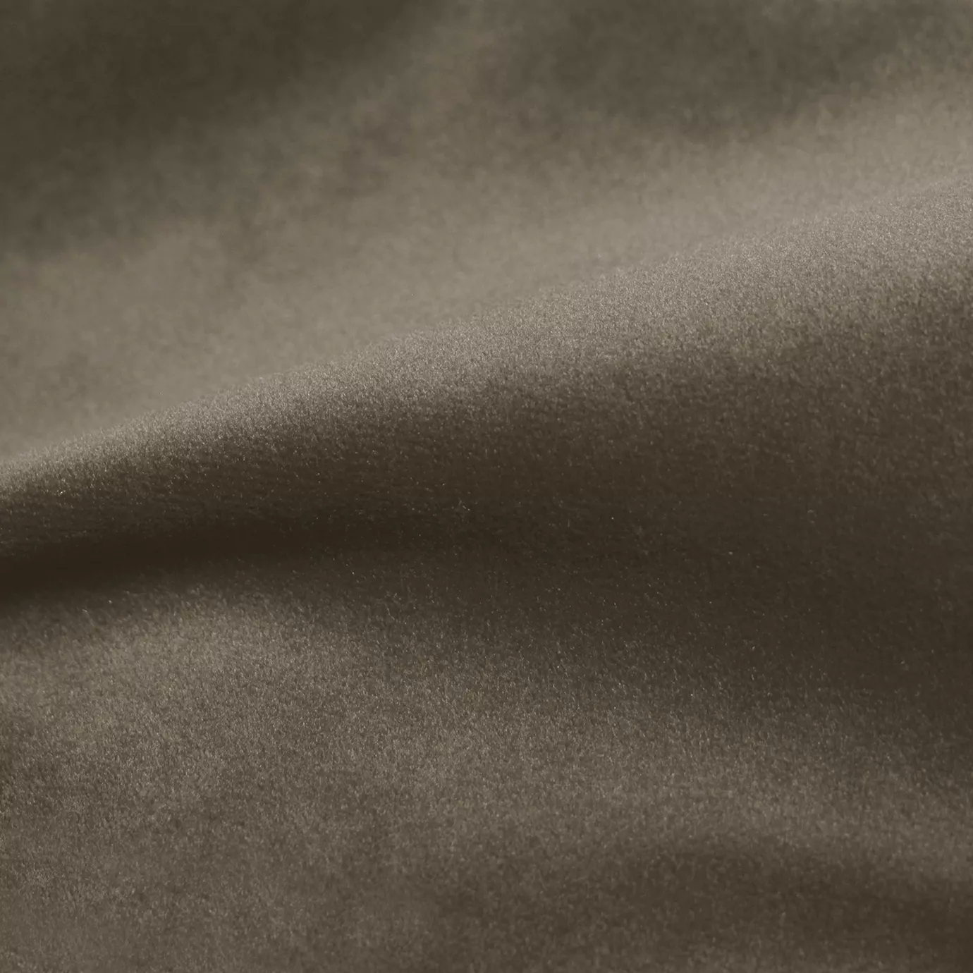 Elegant close-up of a Cozy Velvet Bison fabric swatch in a natural and earthy bison tone, showcasing its velvety texture and the gentle folds that highlight its depth and warmth.