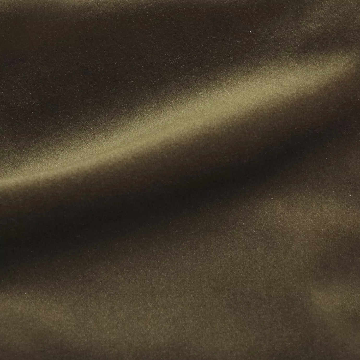 Elegant close-up of a Cozy Velvet Bronze Brown fabric swatch in a rich and deep bronze brown tone, showcasing its velvety texture and the gentle folds that capture light in a luxurious way.