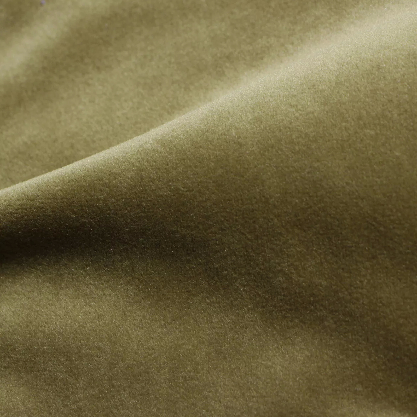 Elegant close-up of a Cozy Velvet Camel fabric swatch in a warm and classic camel tone, showcasing its velvety texture and the gentle folds that give it a sense of comfort and sophistication.