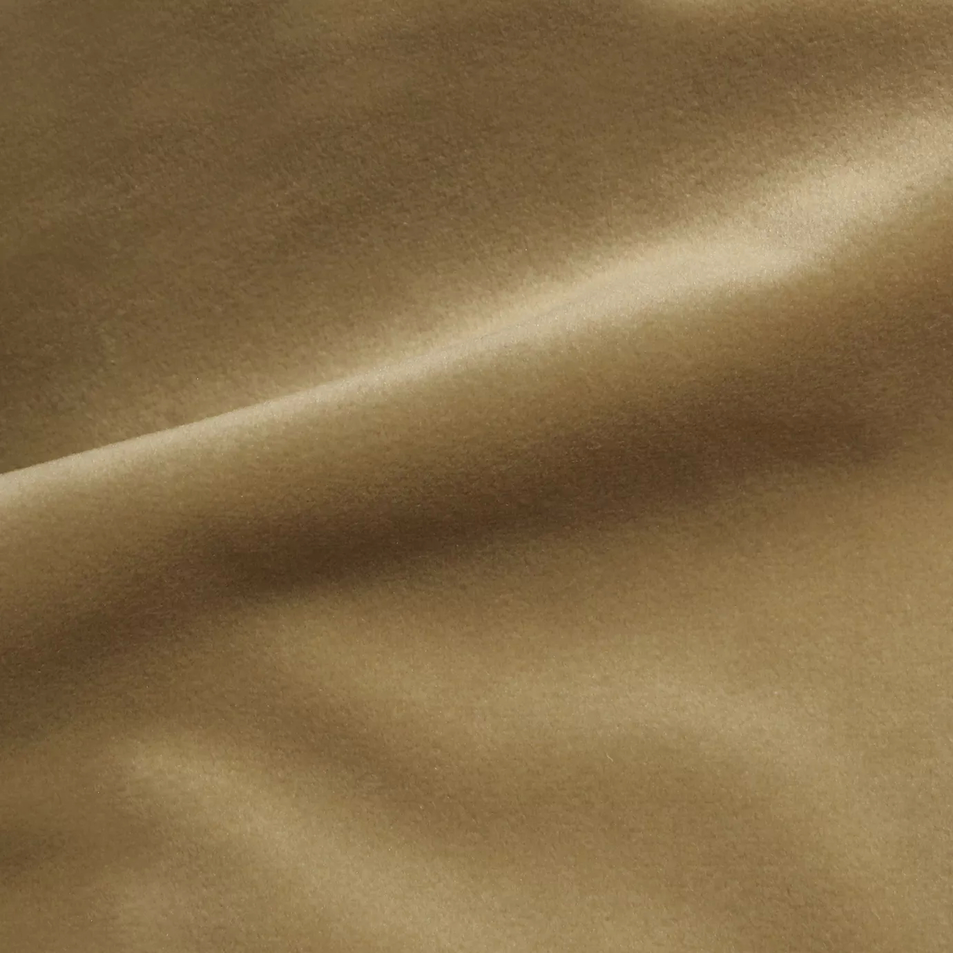 Elegant close-up of a Cozy Velvet fabric swatch in a soft beige tone, showcasing its smooth and slightly lustrous texture with gentle folds.