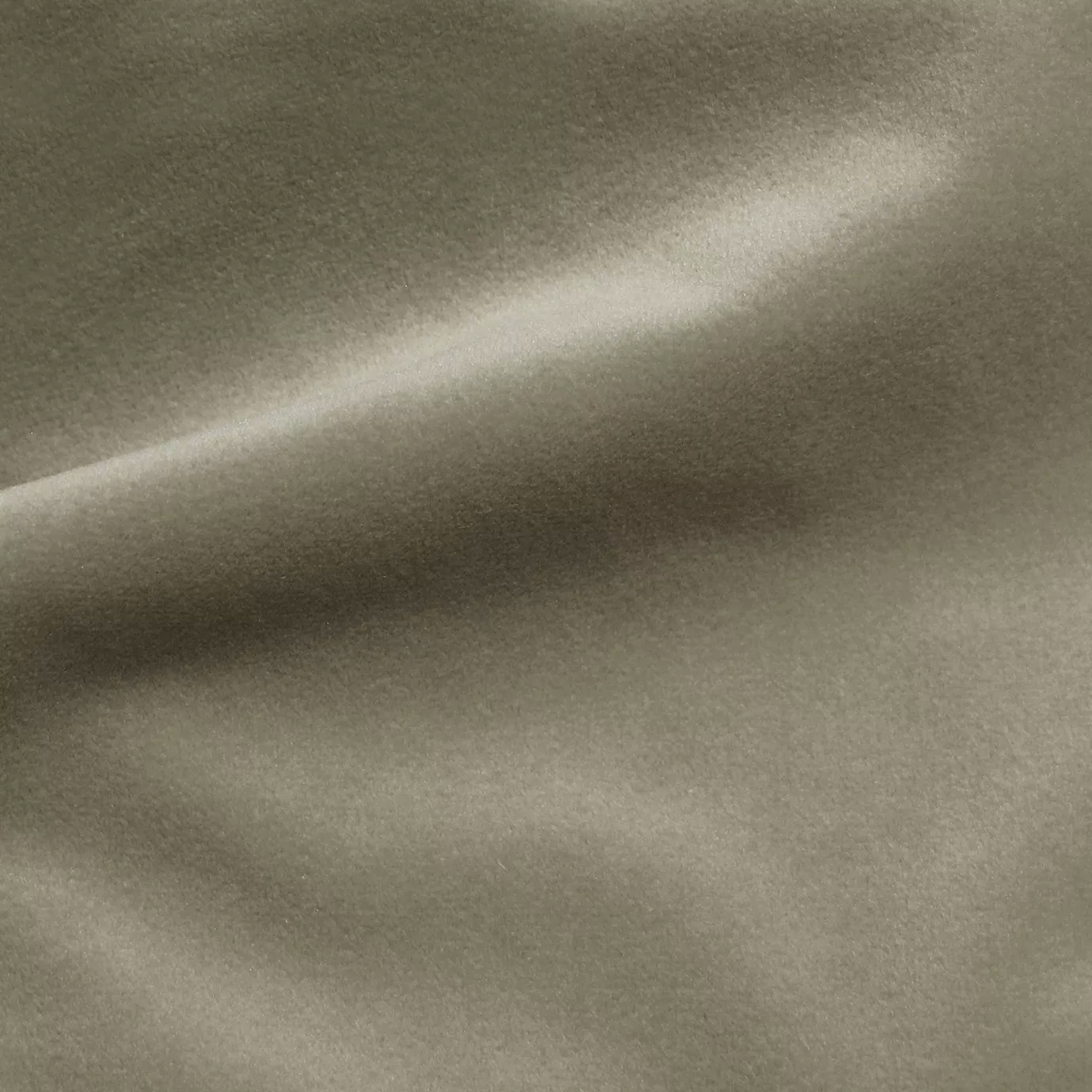 Elegant close-up of a Cozy Velvet Plaza Taupe fabric swatch in a stylish and urban taupe tone, showcasing its velvety texture and the gentle folds that give it an inviting appearance.