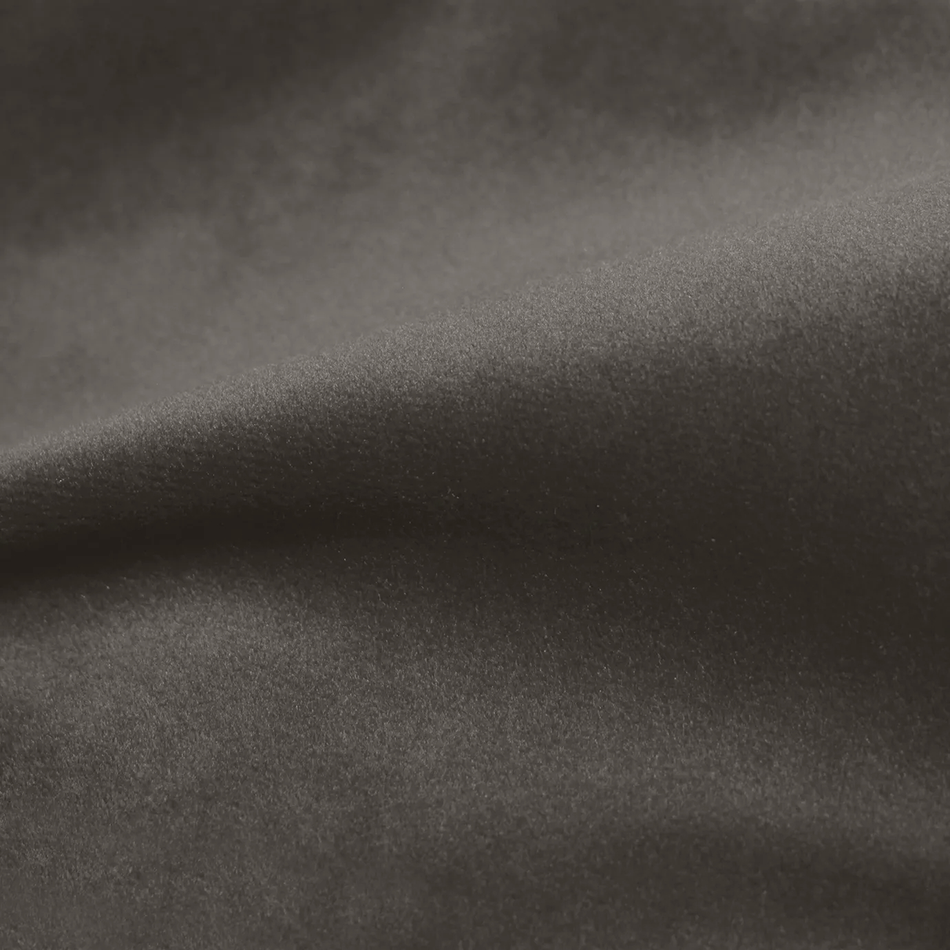 Elegant close-up of a Cozy Velvet Taupe Gray fabric swatch in a sophisticated and warm taupe-gray tone, showcasing its velvety texture and the gentle folds that give it a cozy appearance.